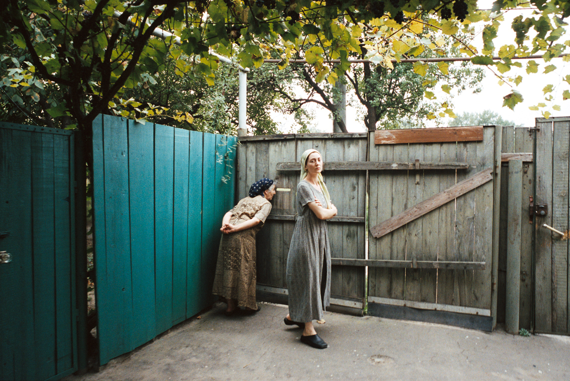 Two Chechen women in a backyard. Photo.