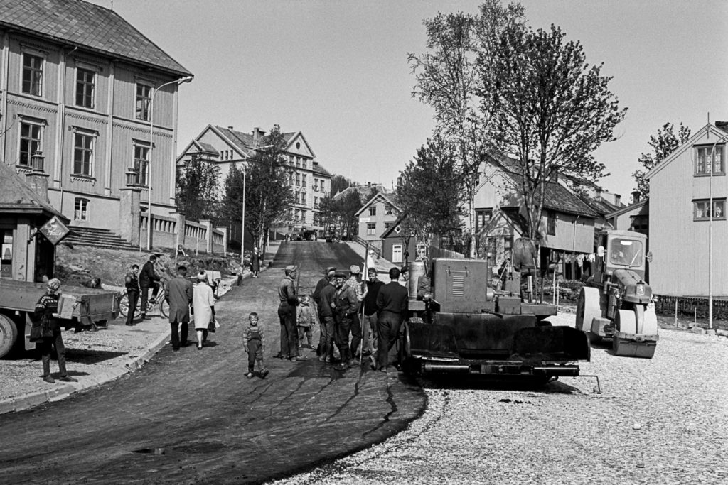 Black and white photograph of streets being paved. 