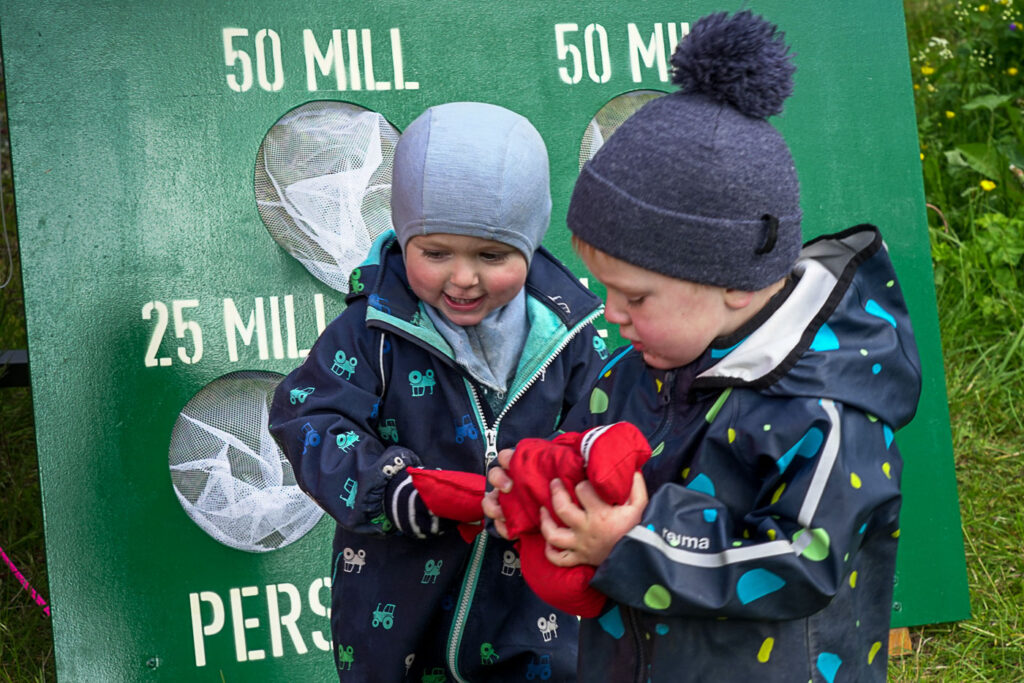 Two young boys holding bean bags